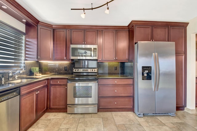 kitchen featuring decorative backsplash, sink, and stainless steel appliances