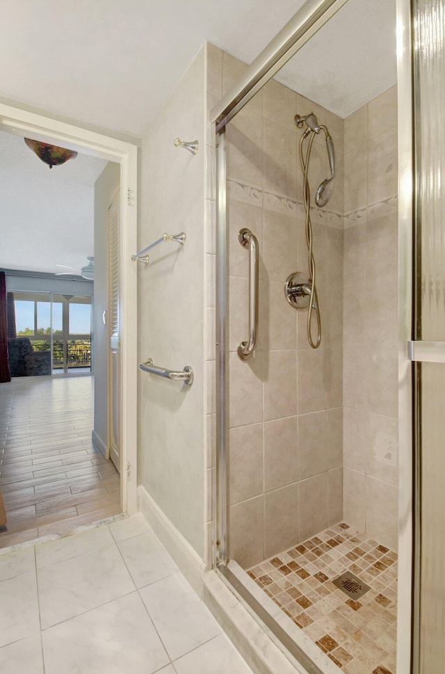 bathroom featuring a shower with door and tile patterned flooring