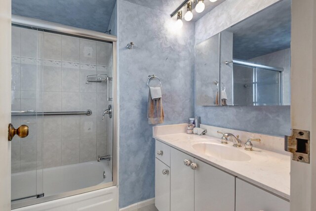 bathroom with vanity and enclosed tub / shower combo