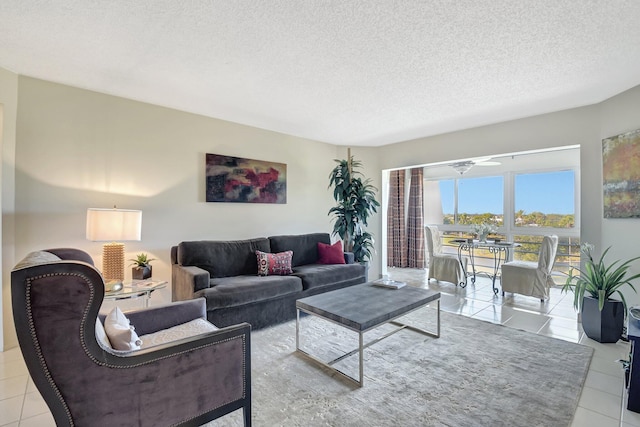 tiled living room featuring a textured ceiling and ceiling fan