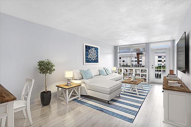 living room with light wood-type flooring and a textured ceiling