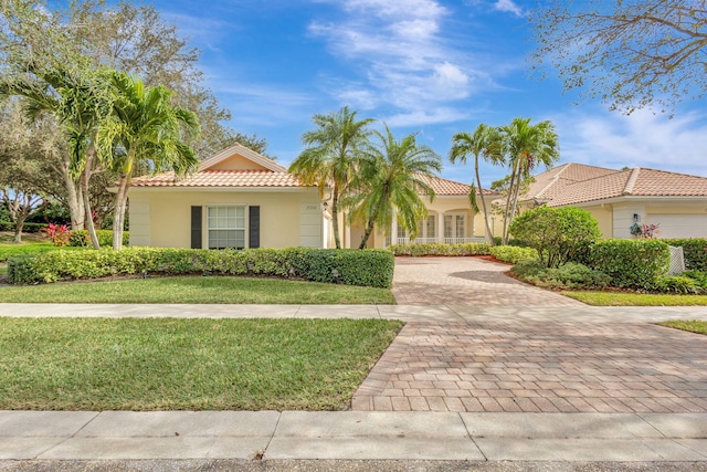 mediterranean / spanish house featuring a front yard