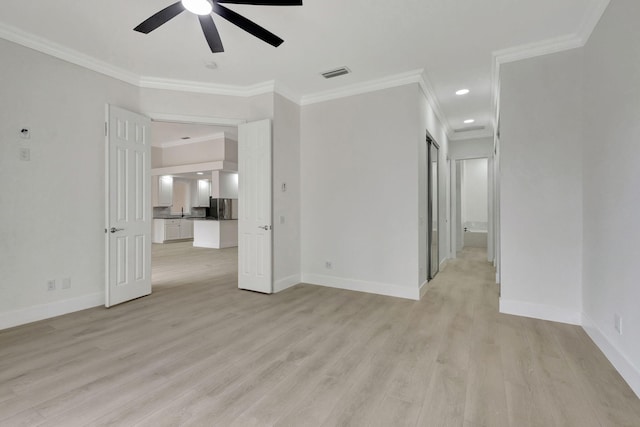 spare room featuring ceiling fan, light wood-type flooring, and crown molding