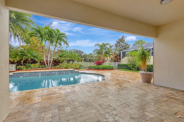 view of swimming pool featuring a lanai and a patio area