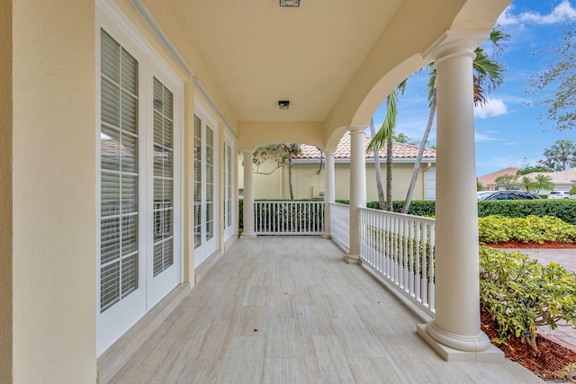 wooden terrace with covered porch and french doors