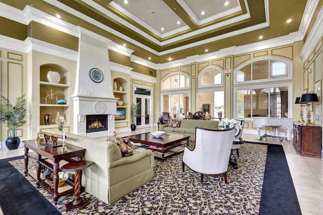 tiled living room with a fireplace, built in shelves, a towering ceiling, and ornamental molding