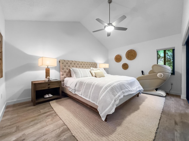 bedroom featuring ceiling fan, vaulted ceiling, and light wood-type flooring