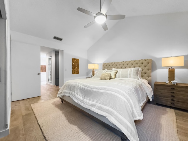 bedroom featuring hardwood / wood-style floors, vaulted ceiling, and ceiling fan