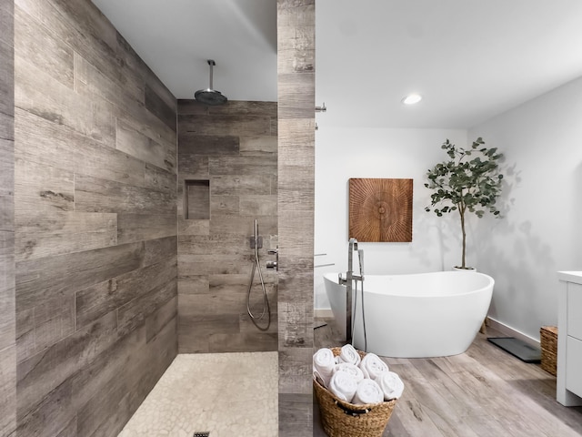 bathroom featuring vanity, independent shower and bath, and hardwood / wood-style flooring