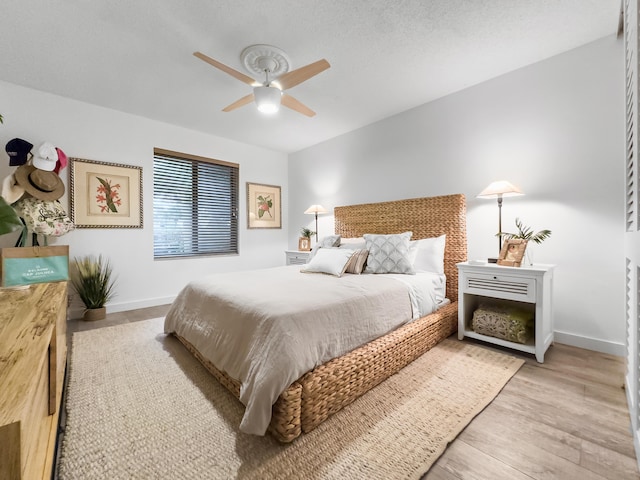 bedroom with light wood-type flooring and ceiling fan