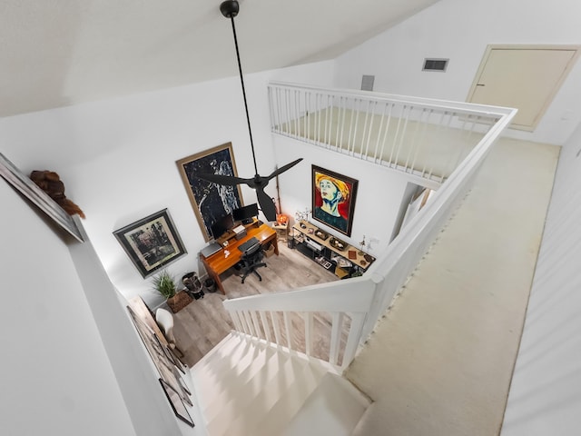 stairway featuring vaulted ceiling