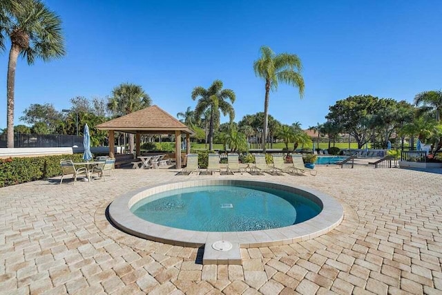 view of swimming pool featuring a gazebo and a patio