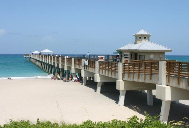 view of home's community featuring a beach view and a water view