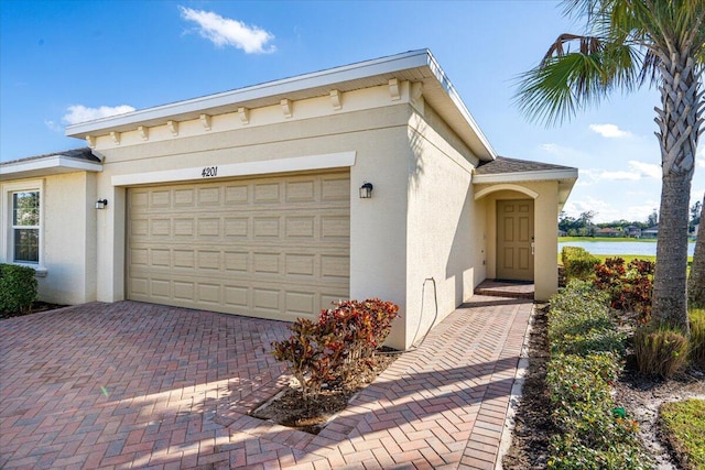 view of front of house featuring a garage and a water view