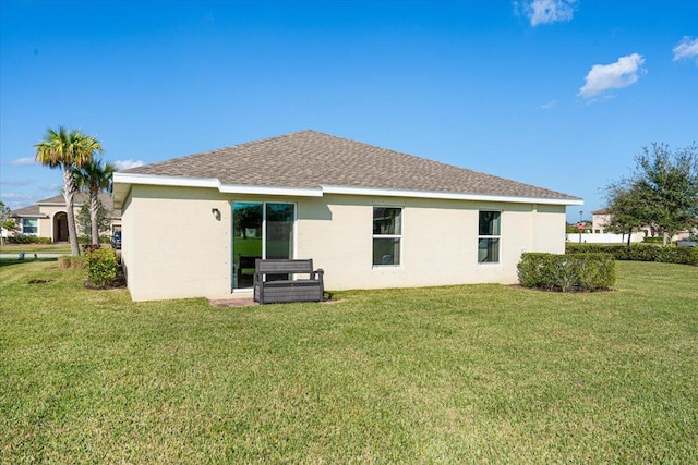 back of house featuring a yard