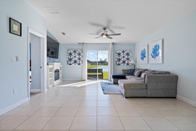 tiled living room featuring ceiling fan