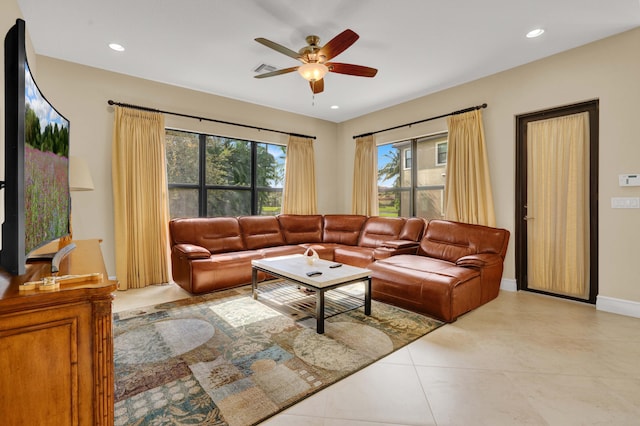 living room featuring light tile patterned floors and ceiling fan