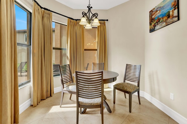 dining space featuring light tile patterned flooring and a chandelier