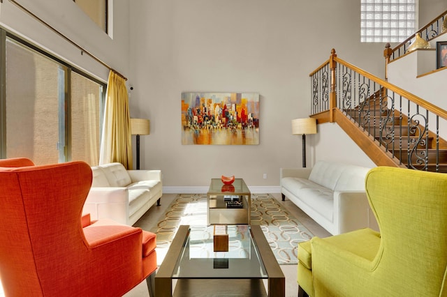 living room featuring a towering ceiling