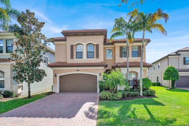 mediterranean / spanish-style house with a front yard and a garage