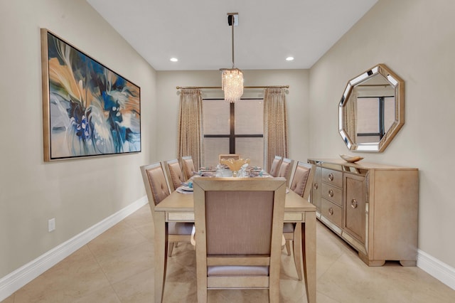 dining area with a chandelier and light tile patterned floors