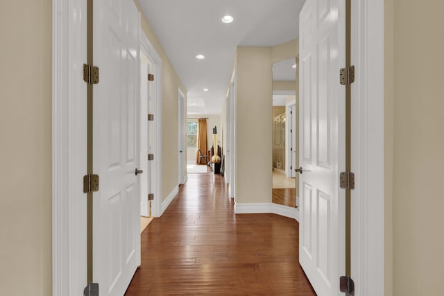 corridor with dark hardwood / wood-style floors