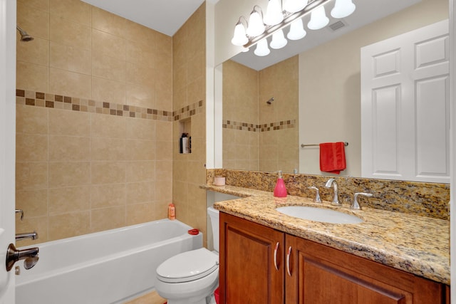 full bathroom featuring vanity, toilet, and tiled shower / bath