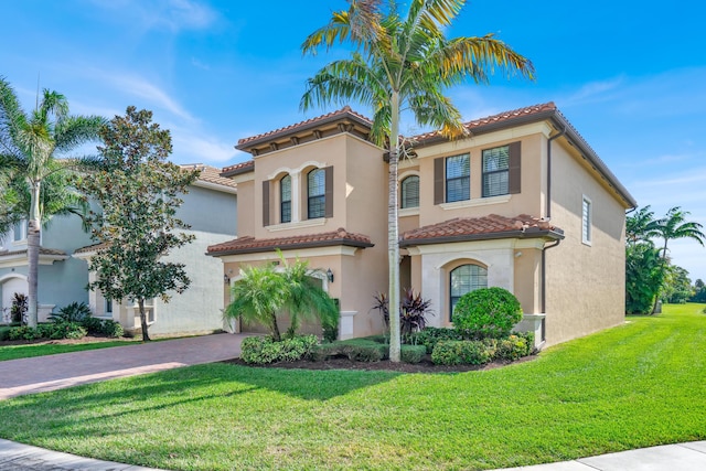 mediterranean / spanish-style house with a front lawn