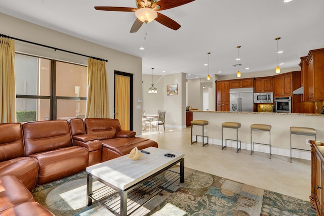 living room with ceiling fan with notable chandelier