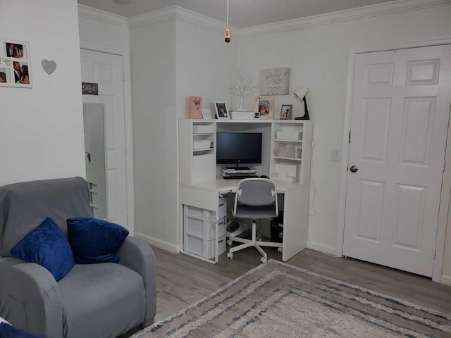 office space featuring light wood-type flooring and crown molding