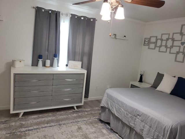 bedroom with ceiling fan, wood-type flooring, and crown molding