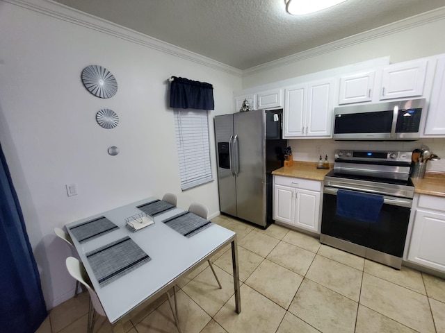 kitchen featuring white cabinets, appliances with stainless steel finishes, and crown molding