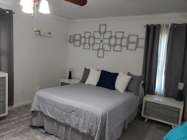 bedroom featuring wood-type flooring, ceiling fan, and crown molding