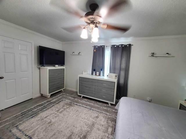 unfurnished bedroom with hardwood / wood-style floors, a textured ceiling, ceiling fan, and ornamental molding