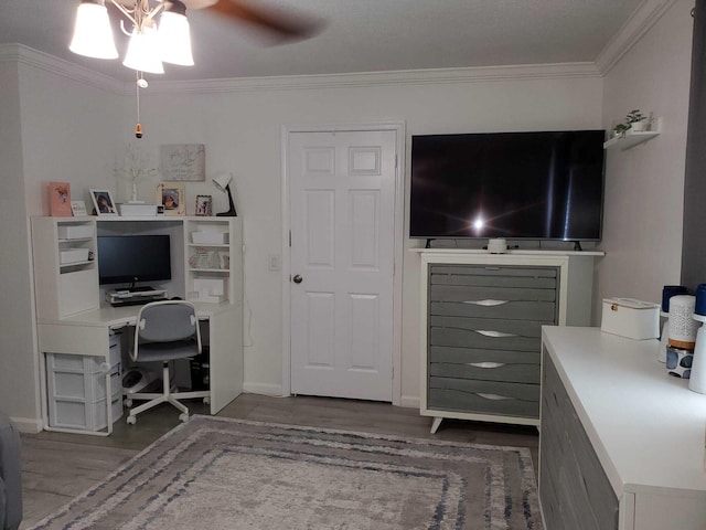 home office with dark hardwood / wood-style floors, ceiling fan, and ornamental molding