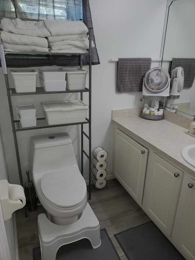 bathroom featuring hardwood / wood-style floors, vanity, and toilet