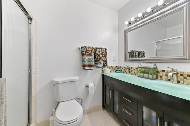 bathroom featuring backsplash, tile patterned floors, an enclosed shower, vanity, and toilet