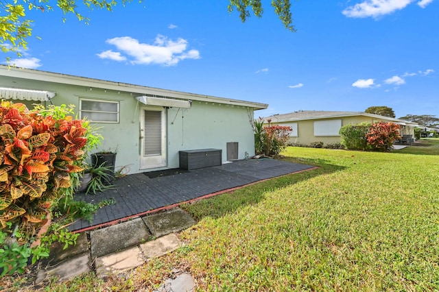 rear view of property featuring a yard