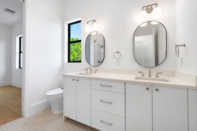 bathroom featuring vanity, toilet, and wood-type flooring