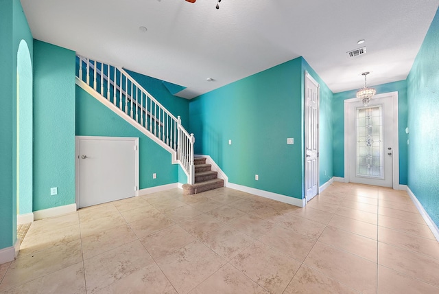 entrance foyer featuring an inviting chandelier