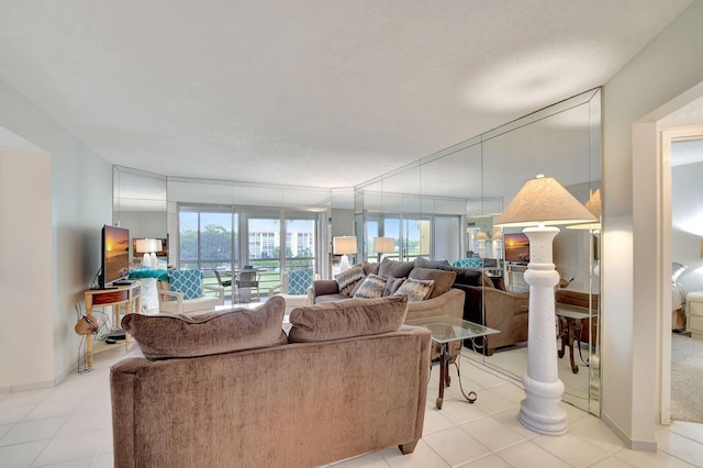 dining space with light tile patterned flooring, a textured ceiling, and a notable chandelier