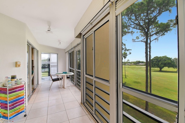 sunroom / solarium featuring ceiling fan and lofted ceiling