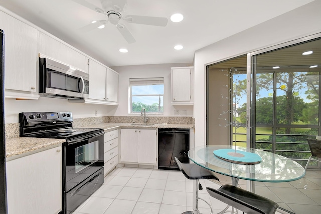 kitchen featuring black appliances, white cabinets, sink, ceiling fan, and light tile patterned flooring