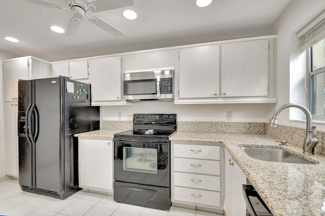 kitchen featuring white cabinetry, sink, ceiling fan, light tile patterned floors, and black appliances