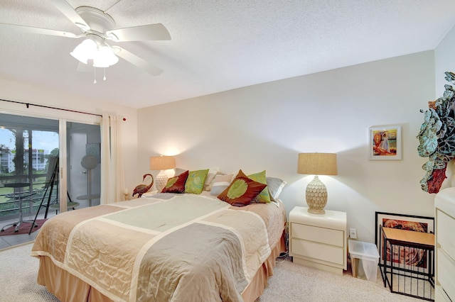 carpeted bedroom featuring access to exterior, a textured ceiling, and ceiling fan