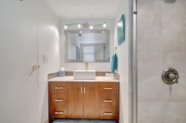 bathroom featuring a shower and vanity