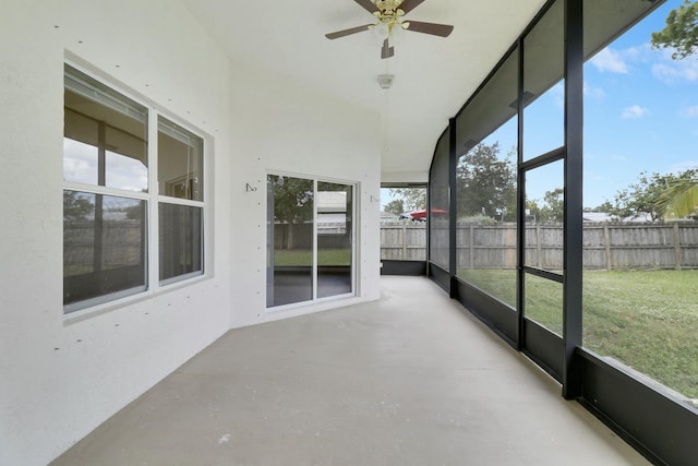 unfurnished sunroom with ceiling fan and a healthy amount of sunlight