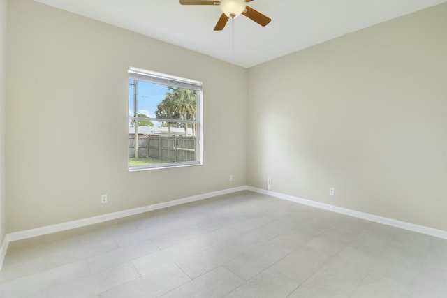 spare room featuring light tile patterned floors and ceiling fan