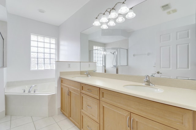 bathroom with plus walk in shower, vanity, and tile patterned flooring