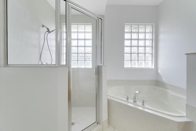 bathroom featuring separate shower and tub and plenty of natural light